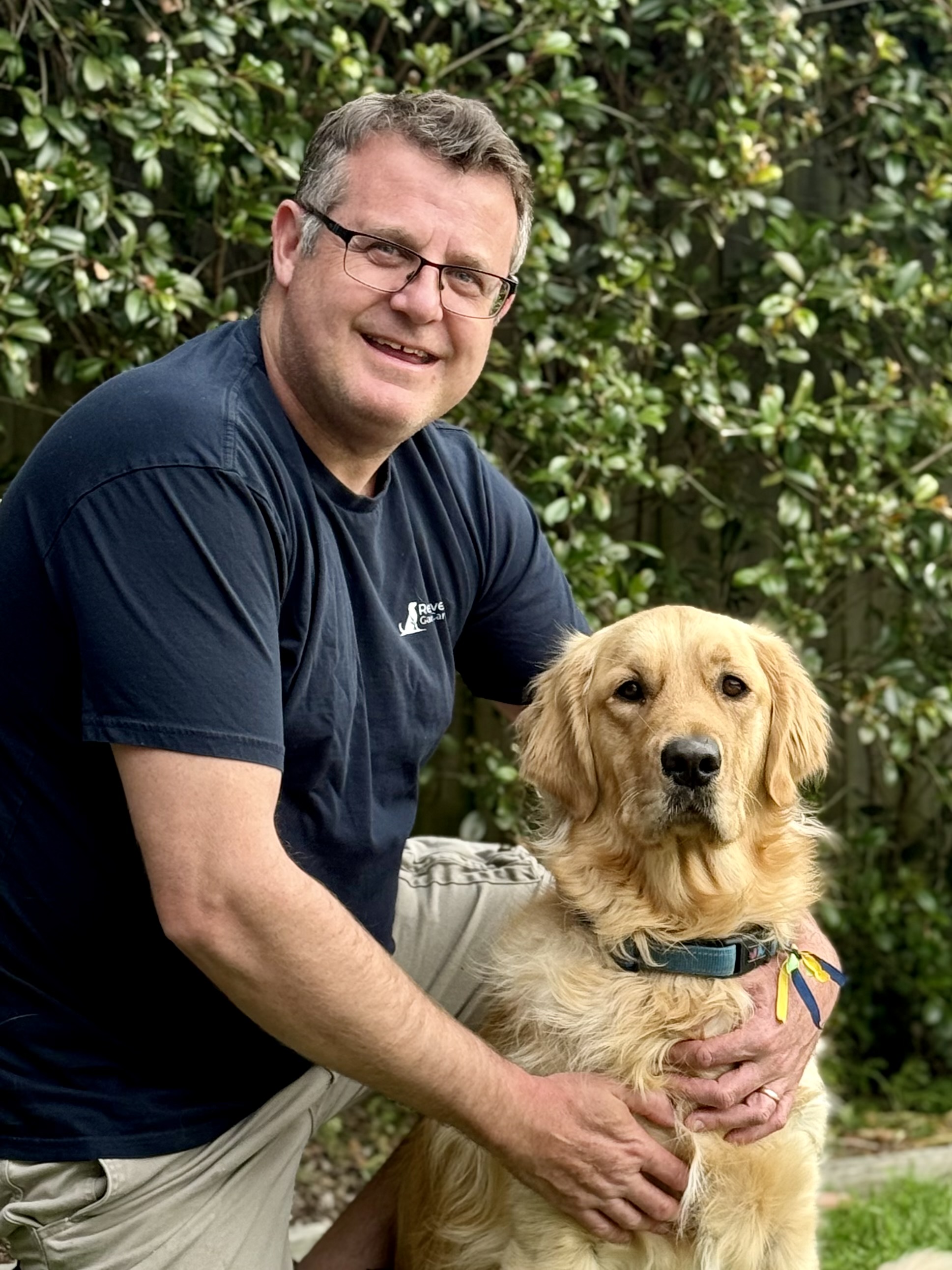 Matt, owner of Retriever Garden Care, his golden retriever Teddy
