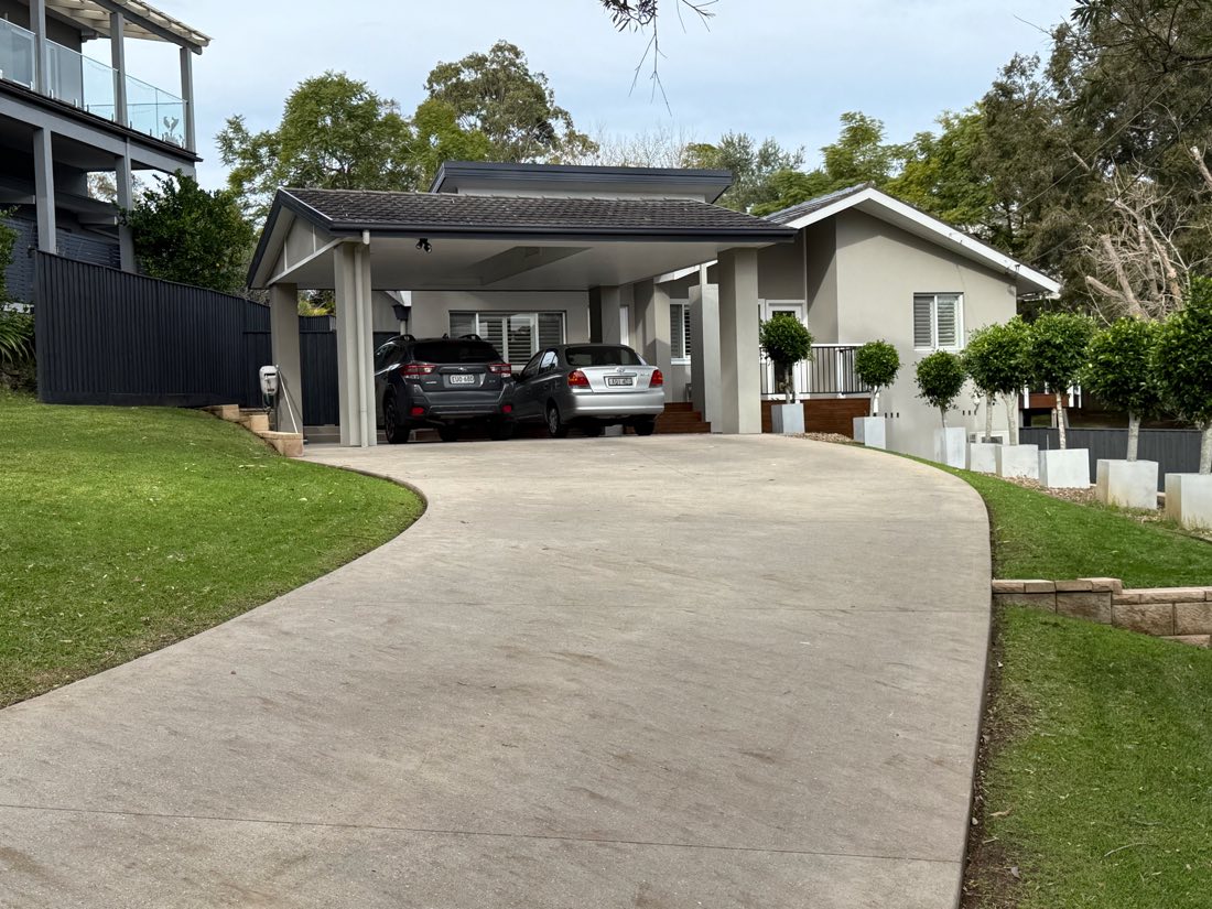 Neat front garden with trimmed lawn and clipped hedges